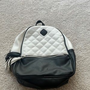Mini adjustable straps black and white, checkered pattern and leathery backpack.